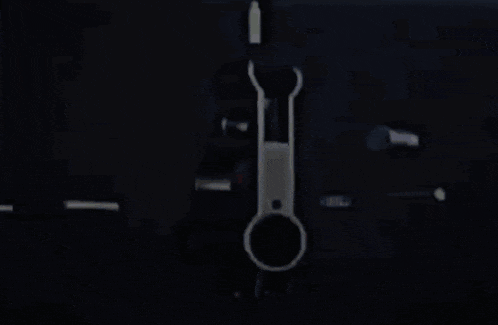a close up of a gun with a red bullet in it