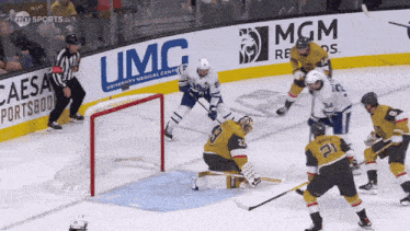 a hockey game is being played in front of a large mgm sign
