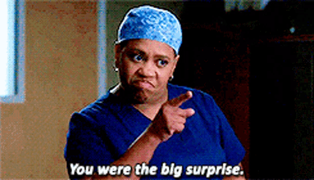 a woman in scrubs is pointing at something and says you were the big surprise