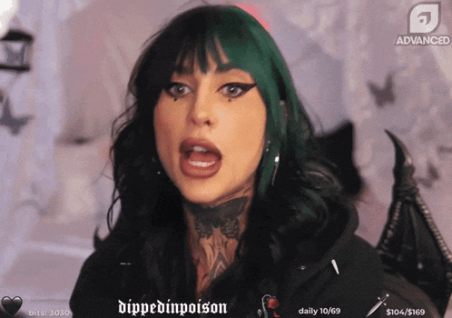 a woman with green hair is on a screen that says " dippedinpoison "