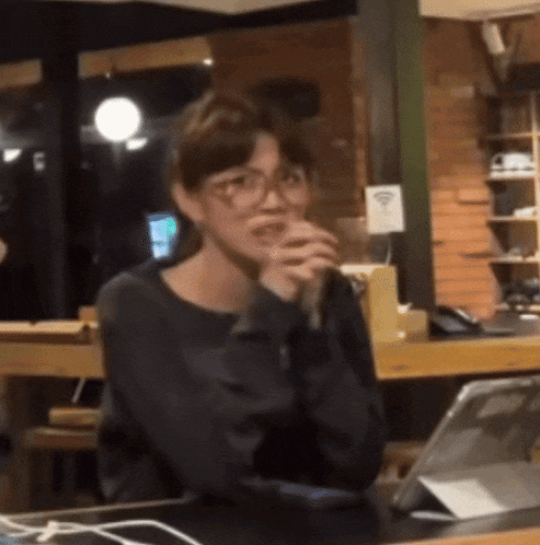 a woman sitting at a table with a tablet and a wifi sign
