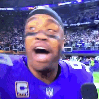 a football player in a purple jersey with the number 6 on it