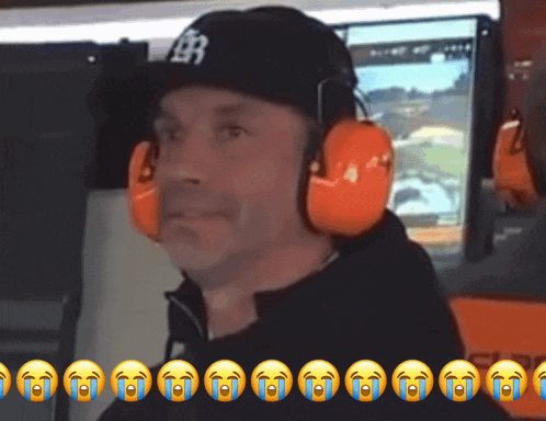 a man wearing ear protectors and a hat with the letter b on it
