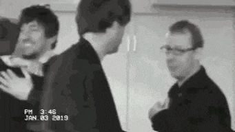 a group of men standing next to each other in a room .
