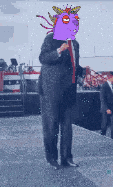 a man in a suit and tie with a purple cartoon character on his head