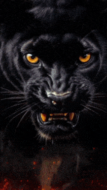 a close up of a black panther 's face with a glowing diamond in its mouth