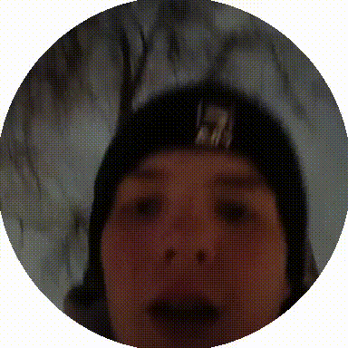 a close up of a person 's face in a circle with trees in the background ..