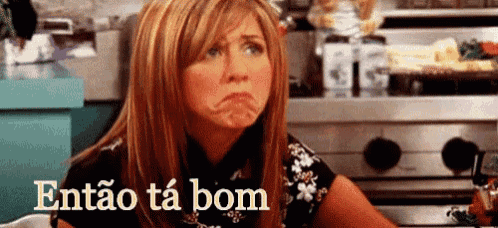 a woman is making a funny face in a kitchen with the words então ta bom above her