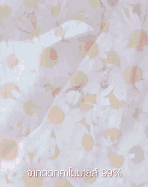 a close up of a woman 's legs with a pink cloth covering them and a foreign language on the bottom