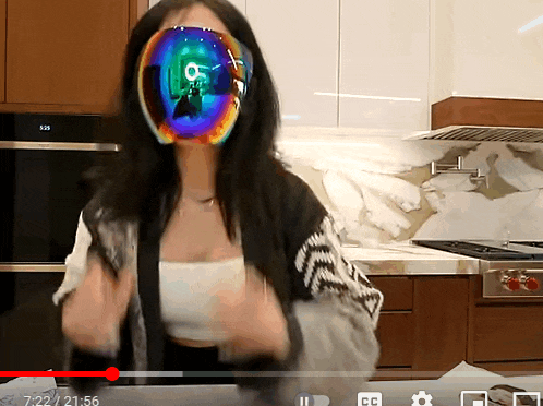 a video of a woman with a colorful mask on her face is being played on youtube