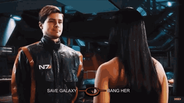 a man in a n7 jacket talks to a woman in a black tank top