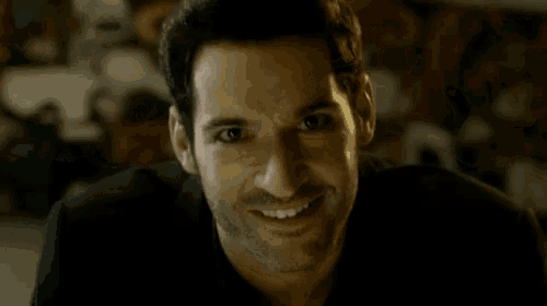 a close up of a man 's face with a smile on his face .