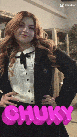 a girl in a school uniform with the word chucky in pink letters