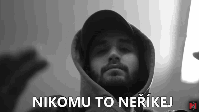 a black and white photo of a man with the words nikomu to nerikej written below him