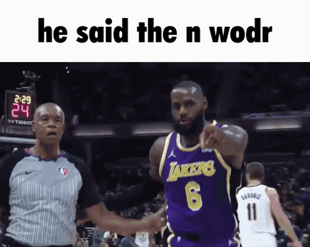a basketball player wearing a lakers jersey is pointing at another player