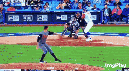 a baseball game is being played in front of a crowd and a new era banner