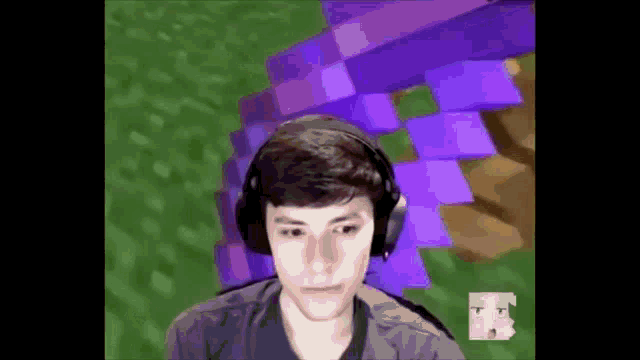a young man wearing headphones is playing a video game in front of a purple background .