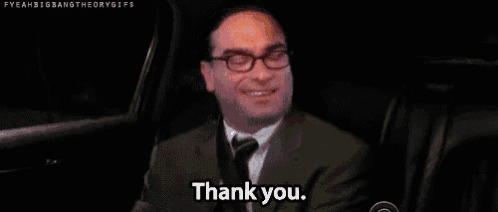 a man in a suit and tie is sitting in the back seat of a car and smiling .