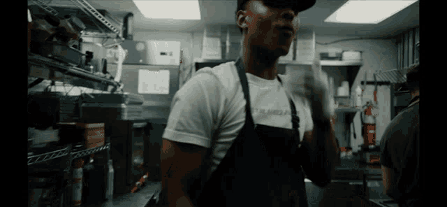 a man wearing an apron and a t-shirt that says columbia on it