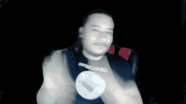 a blurry picture of a man wearing a shirt that says ' insomnia ' on it