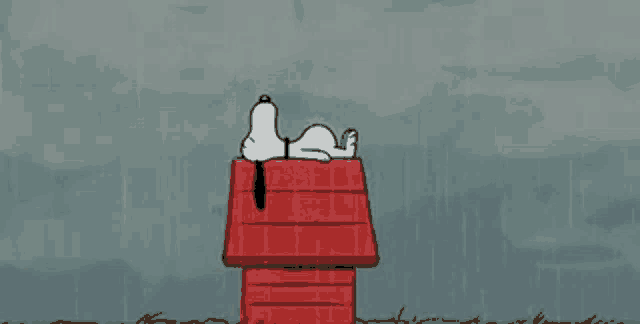 a cartoon of snoopy laying on top of a red house in the rain .