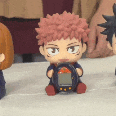 a person is holding a toy that looks like a cartoon character holding a device .
