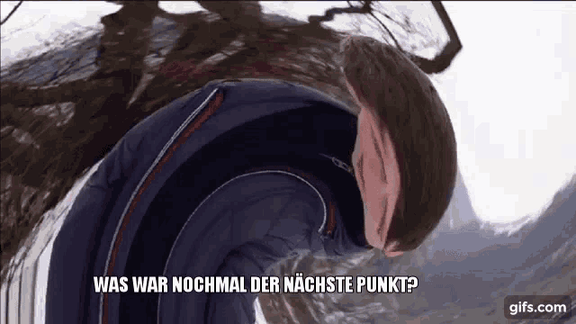 a man in a blue jacket says " was war nochmal der nächste punkt " in german