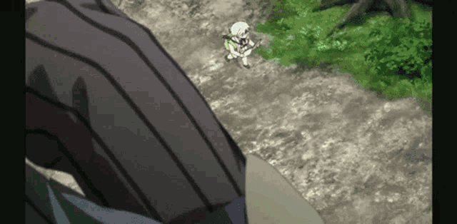 a person is standing on a dirt road next to a skeleton .
