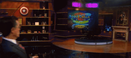 a man in a suit and tie is dancing in front of a sign that says super colbchol