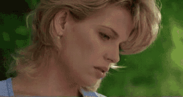 a close up of a woman 's face with her mouth open and her neck visible .