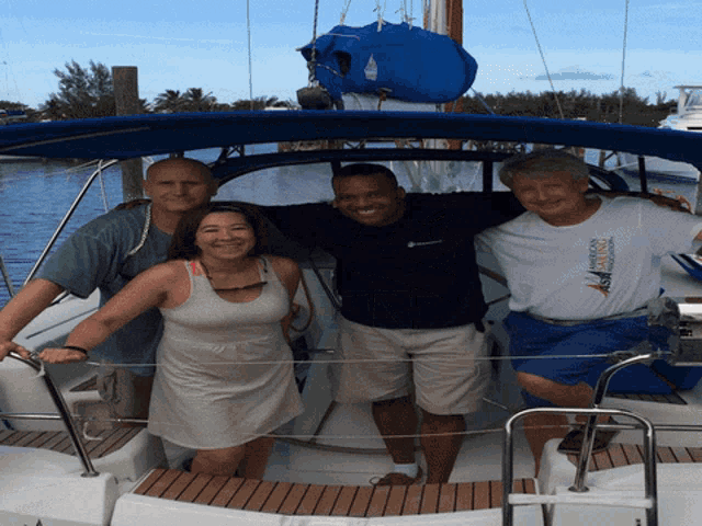 a group of people posing for a picture on a boat one of them is wearing a shirt that says florida keys