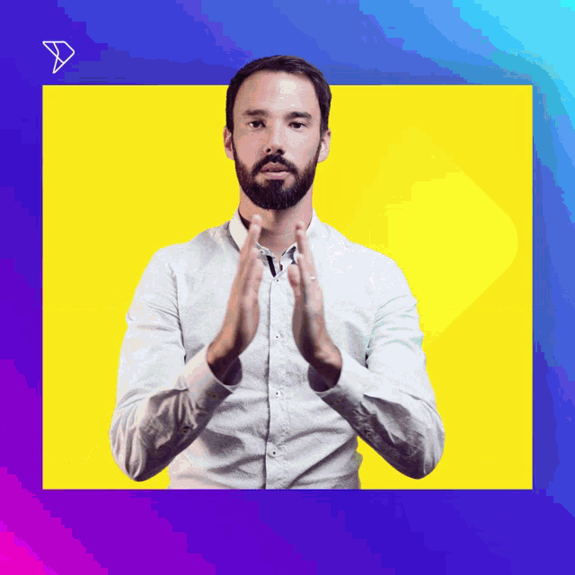 a man in a white shirt is clapping his hands in front of a yellow background