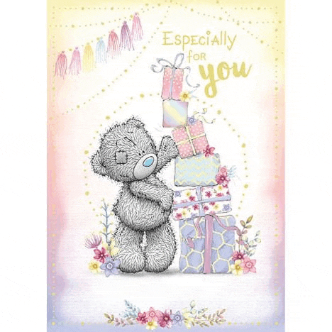 a teddy bear is standing next to a pile of gifts and flowers .