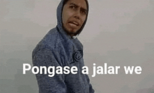 a man in a blue hoodie is standing in front of a white wall with the words pongase a jalar we .