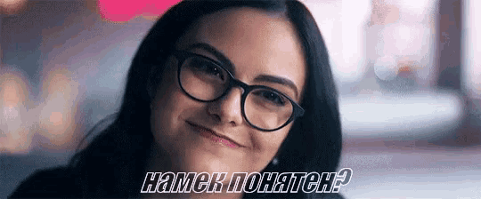a close up of a woman wearing glasses and smiling