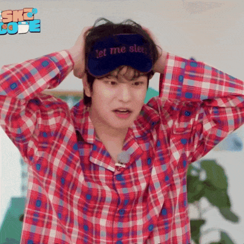 a man wearing a sleep mask that says let me sleep on it