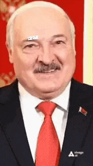 a man with a mustache is wearing a suit and red tie .