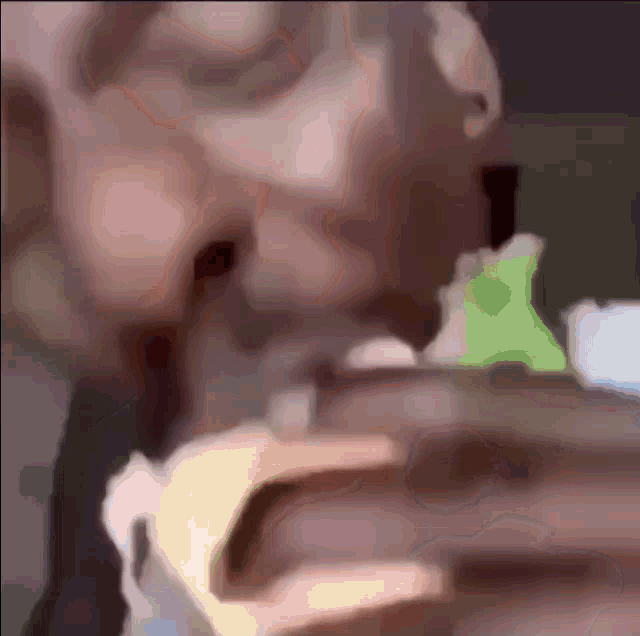 a close up of a person 's face with a frog in the background