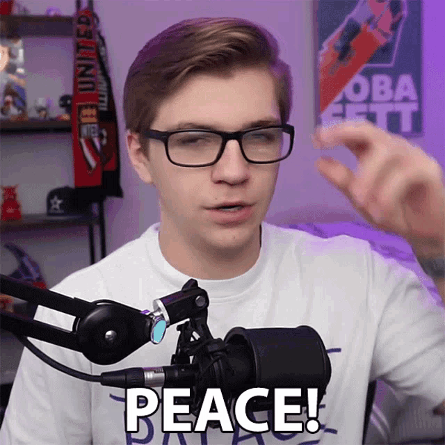 a man wearing glasses and a shirt that says peace