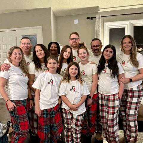 a group of people wearing pajamas and shirts with the letter g on them pose for a picture