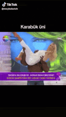 a man is carrying a woman in his arms on a tv show