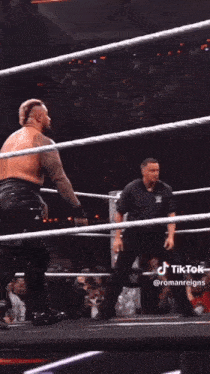 a wrestler is being lifted in the air by another wrestler during a match