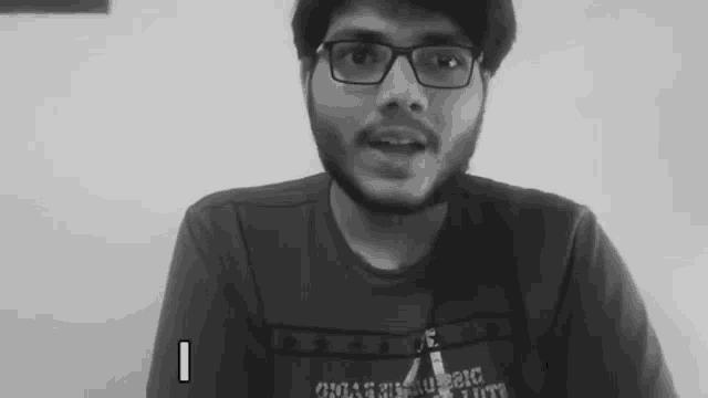 a black and white photo of a man wearing glasses and a t-shirt that says chicago .