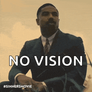 a man in a suit and tie is sitting in the grass with the words no vision behind him