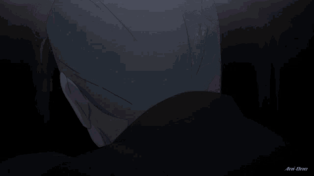 a close up of a man 's face with an anime logo in the bottom right corner