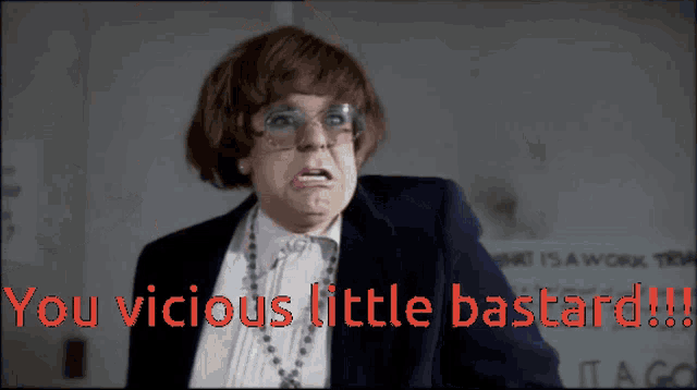 a man in a suit and glasses says " you vicious little bastard !! "
