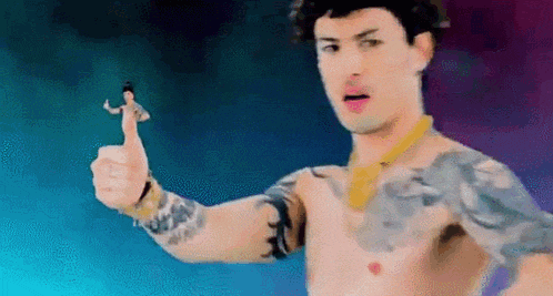 a shirtless man with a tattoo on his arm is giving a thumbs up while holding a small doll .
