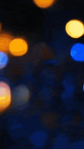 a bunch of confetti is falling on a black background .