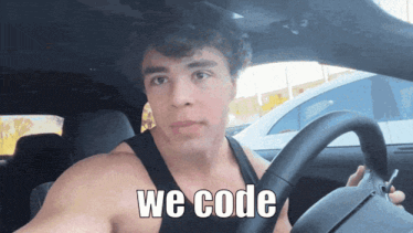 a shirtless man is driving a car with the words we code written on the steering wheel