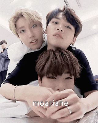 a group of young men are laying on top of each other with the word moariane written on the bottom .